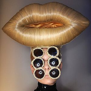 Ein Model trägt Charlie Le Mindus Blonde Lips auf dem Kopf